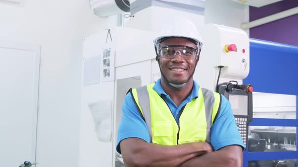 African worker people wearing protective safety helmet and glasses in production line of factory.