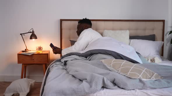 Wide Shot African American Young Man Waking Up Checking Time Hurrying Leaving Bedroom