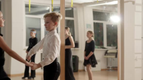 Couple of Children Rehearsing Samba or Rumba Dance in Dancing School