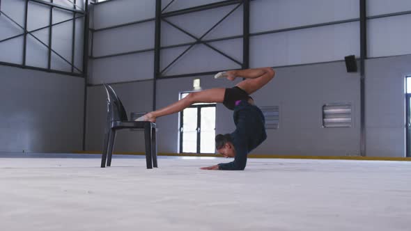 Female gymnast performing at sports hall