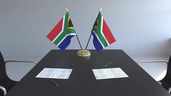 Flags of South Africa and Papers on the Table