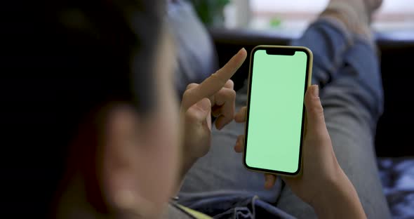 Close up shot of a woman using a smart phone with green screen