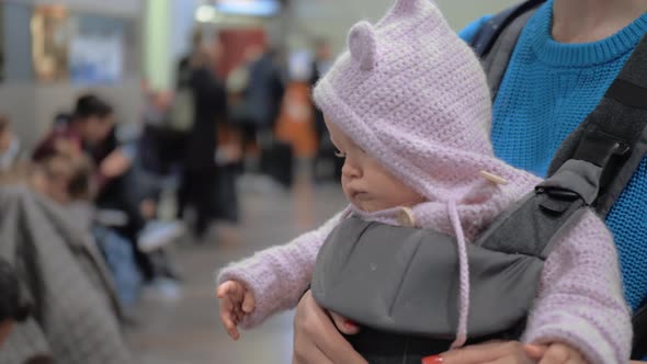 Mum with Baby Daughter in Kangaroo Carrier at the Airport