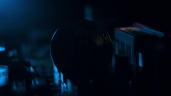 Golden Bitcoin Cryptocurrency on a Computer Board. Macro Shooting. The Concept of Cryptocurrency