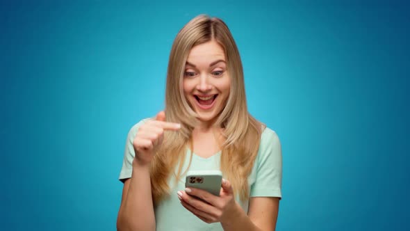 Young Woman Using Her Smartphone in Studio