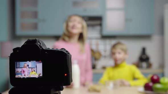 Woman and Boy Prepare Breakfast of Muesli and Milk and Shoot Video on Camera