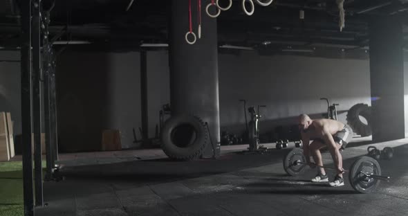 Athletic Man Doing Clean and Jerk Exercise Barbell in Gym