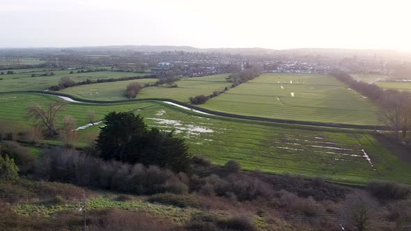 Glastonbury levels and rural farmland with fields, river and houses in the county of Somerset, Engla