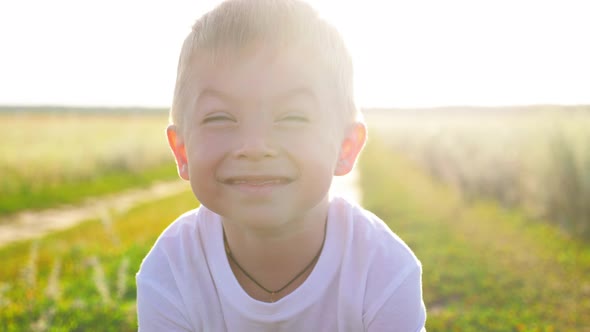 Closeup Face of Little Boy Looking to Camera on the Nature