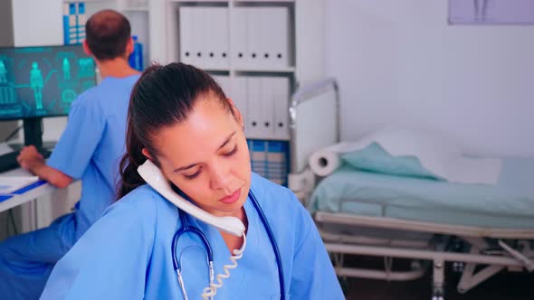 Medical Radiologist Answering Patient Call By Phone