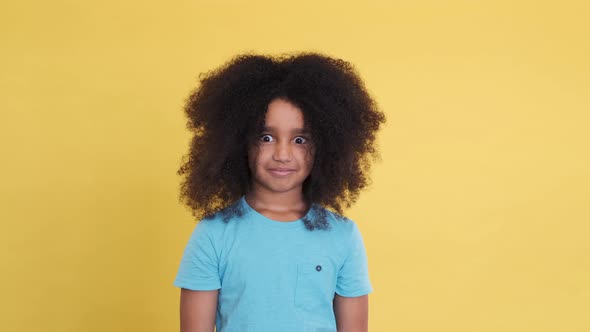 Amazed Shocked Small African American Girl with Wide Open Eyes