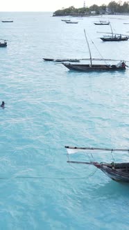 Vertical Video Boats in the Ocean Near the Coast of Zanzibar Tanzania