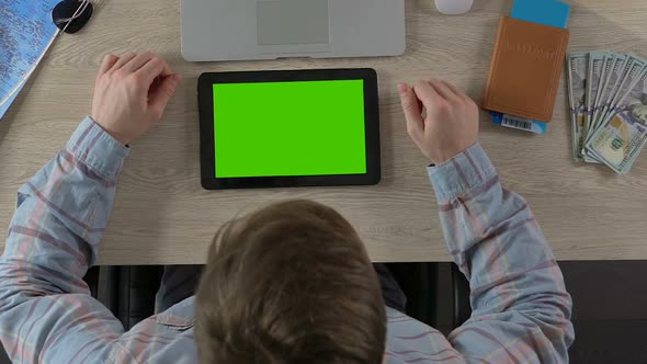 Close-Up of Traveler Viewing Photos of Landmarks on Green Screen Tablet, Tourism