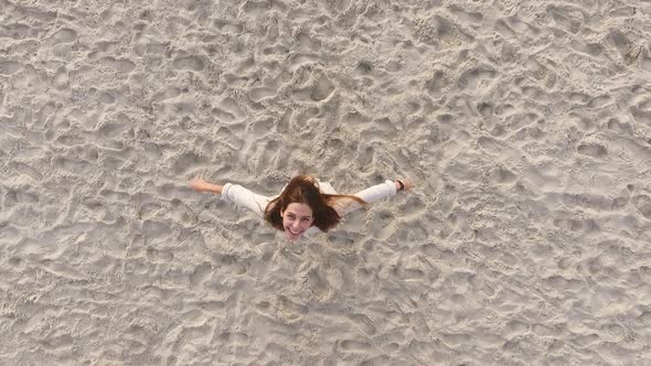 Footage From Copter Happy Attractive Girl with Long Dark Hair Spinning with Stretched Out Arms