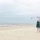 Couple flying kite by the sea - VideoHive Item for Sale