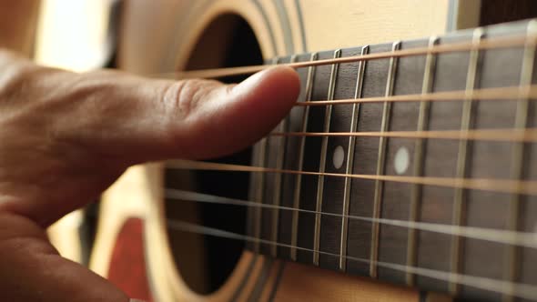 Close Up. The Fingers of the Musician To Touch the Strings of the Guitar. A Man Plays an Acoustic