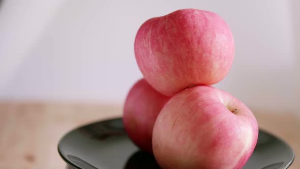 A showcase of colorful tasty apple on a rotating surface it has bright red color and looks very appe