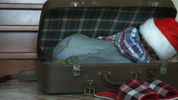 Little Santa Sleeping in Suitcase.