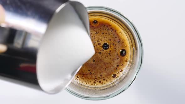 Pouring Milk into Coffee Cup