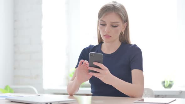 Successful Woman Celebrating on Smartphone