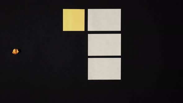 Note paper appears in stop motion on black surface alt