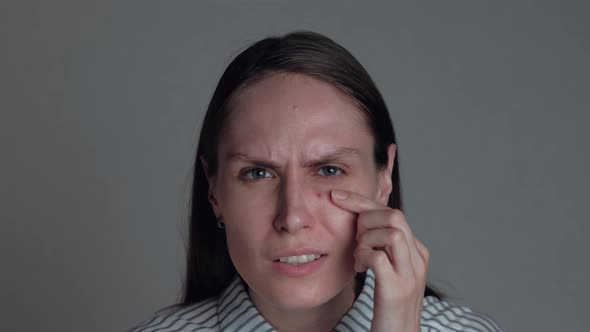 Portrait of Female Popping Pimple