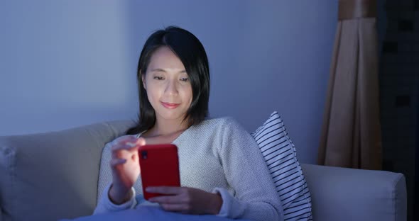 Woman read on smart phone in city at night