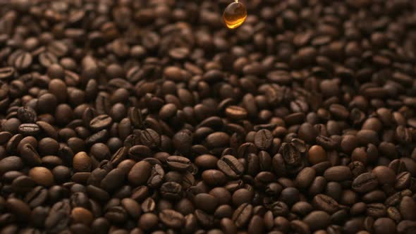 Pouring coffee over coffee beans, Slow Motion