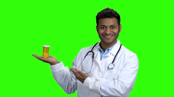 Smiling Doctor Presenting Pills on Green Screen