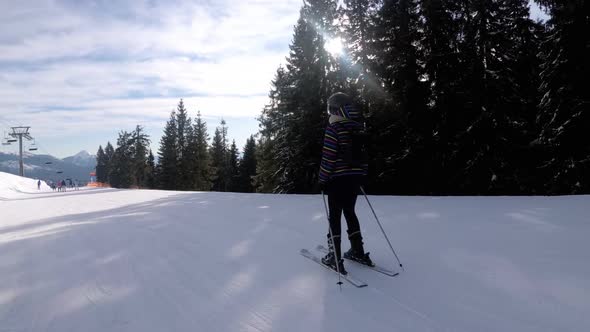 POV Beginner Girl on Skis and Amateur Skiers Slide Down on Ski Slope at Ski Resort