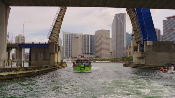 Boat floating under a bascule bridge in Miami