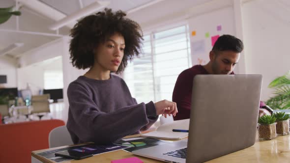 Two colleagues working in creative office