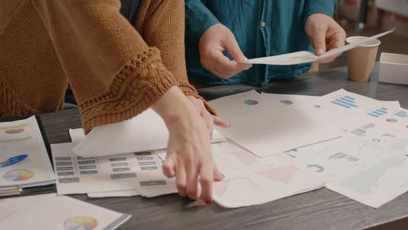 Close Up of People Checking Papers with Data Rate Charts