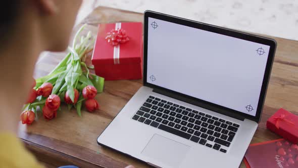 Biracial woman having valentines video call on smartphone with copy space