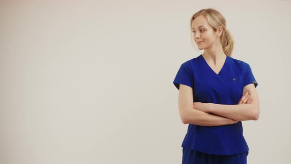 European Middleaged Female Doctor in a Dark Blue Outfit Over Soft Gray Background