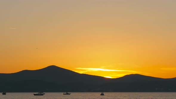 Boats floating on the sea at sunset