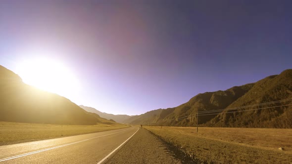 Mountain Road Timelapse at the Summer or Autumn Sunset Sunrise Time. Wild Nature and Rural Field.