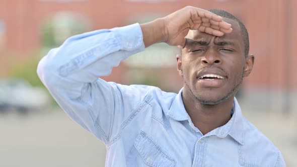 Outdoor Portrait of Curious African Man Searching for Opportunities 