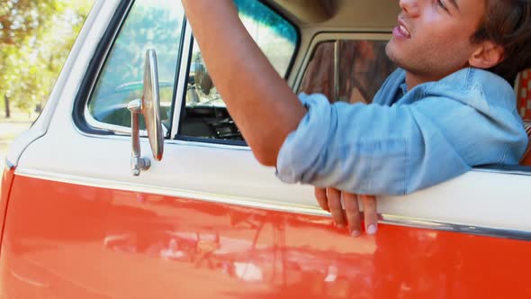 Man using mobile phone in camper van