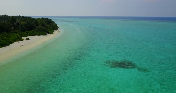 Tropical drone copy space shot of a white sandy paradise beach and aqua blue ocean background in col