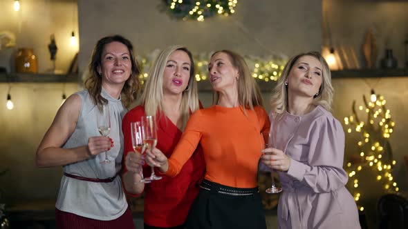 Four Beautiful Blonde Women are Dancing in New Year Party at Home