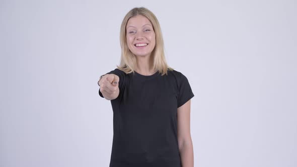 Young Happy Blonde Woman Pointing at Camera