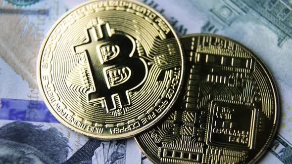 Bitcoin BTC coin rotate on 100 dollars USD bills. blockchain, mining GPU