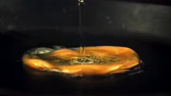 Super Slow Motion Raw Egg Falls on a Hot Frying Pan