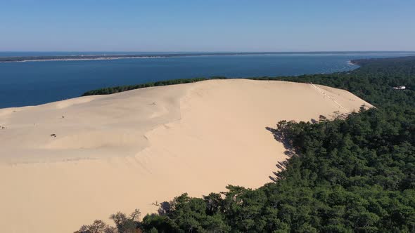 Sandhill with a staircase at Dune du Pilat with Cap Ferret in the distance, Aerial pan left shot