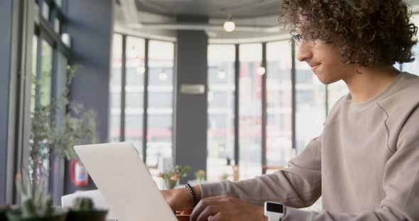 Man using laptop and mobile phone