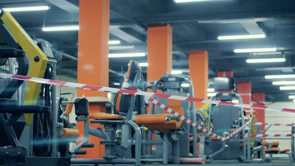 Barricade Tape Pulled Around the Fitness Machines in the Gym