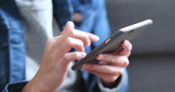 Woman using mobile phone at home