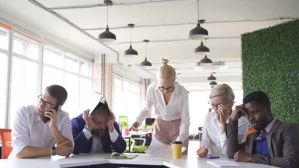 Furious Female Director Dissatisfied with Work She Yells at Emplyees Holding Papers Documents in