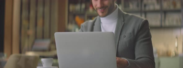 Successful adult man working on laptop